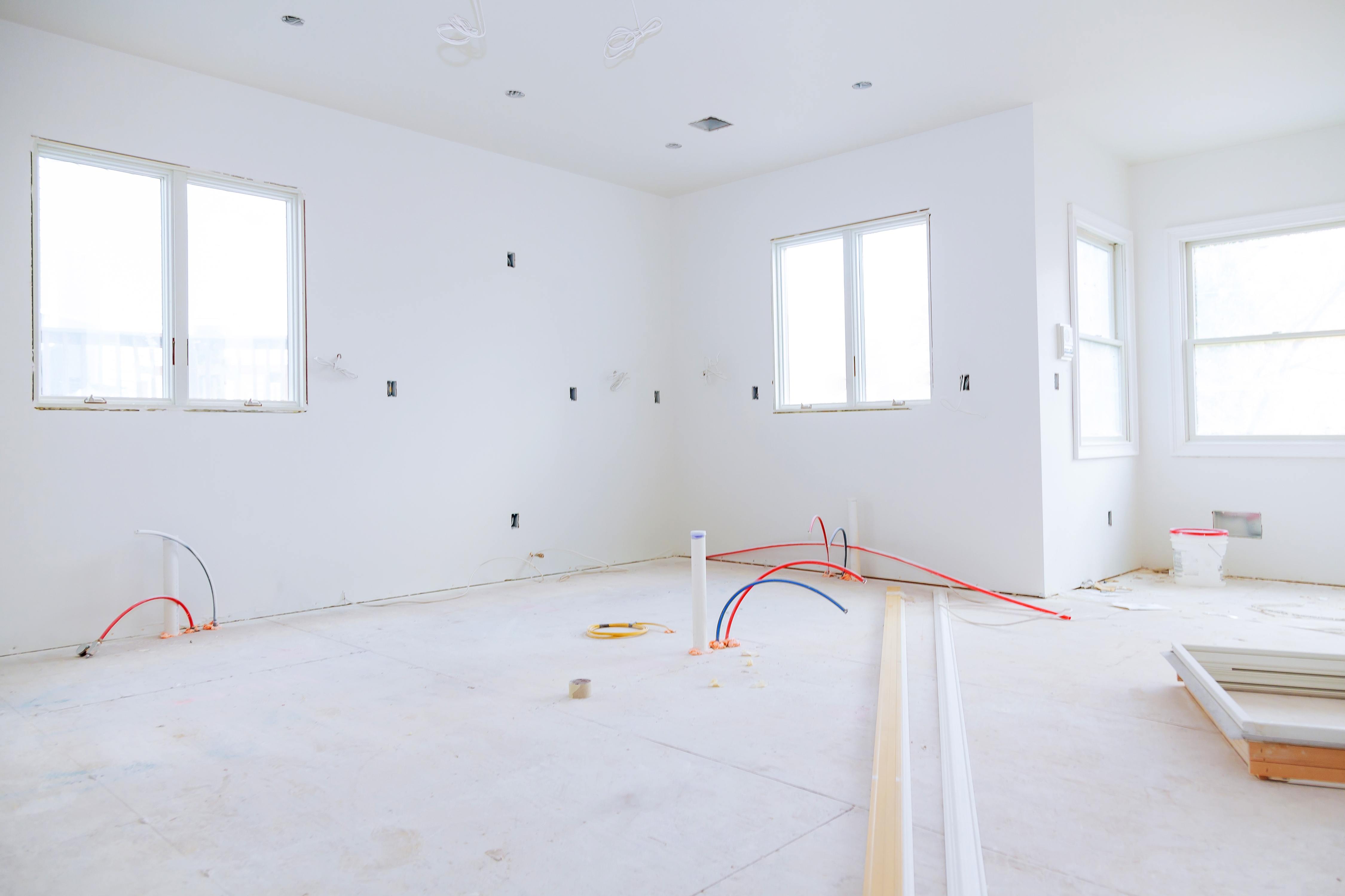 Interior construction of housing project with drywall installed and patched without building is a